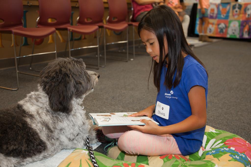 Olivia reading to Sierra the dog