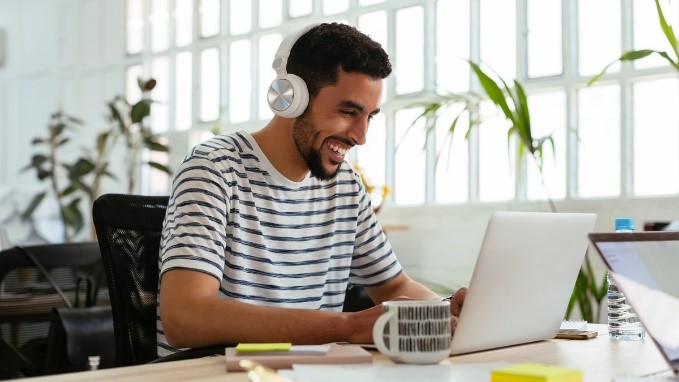 man smiling at laptop