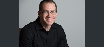 man with glasses smiling